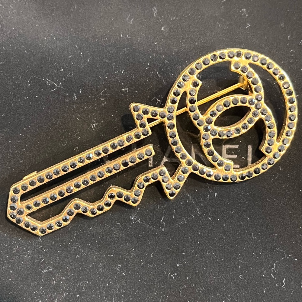 Authentic Chanel gold and Crystal key brooch